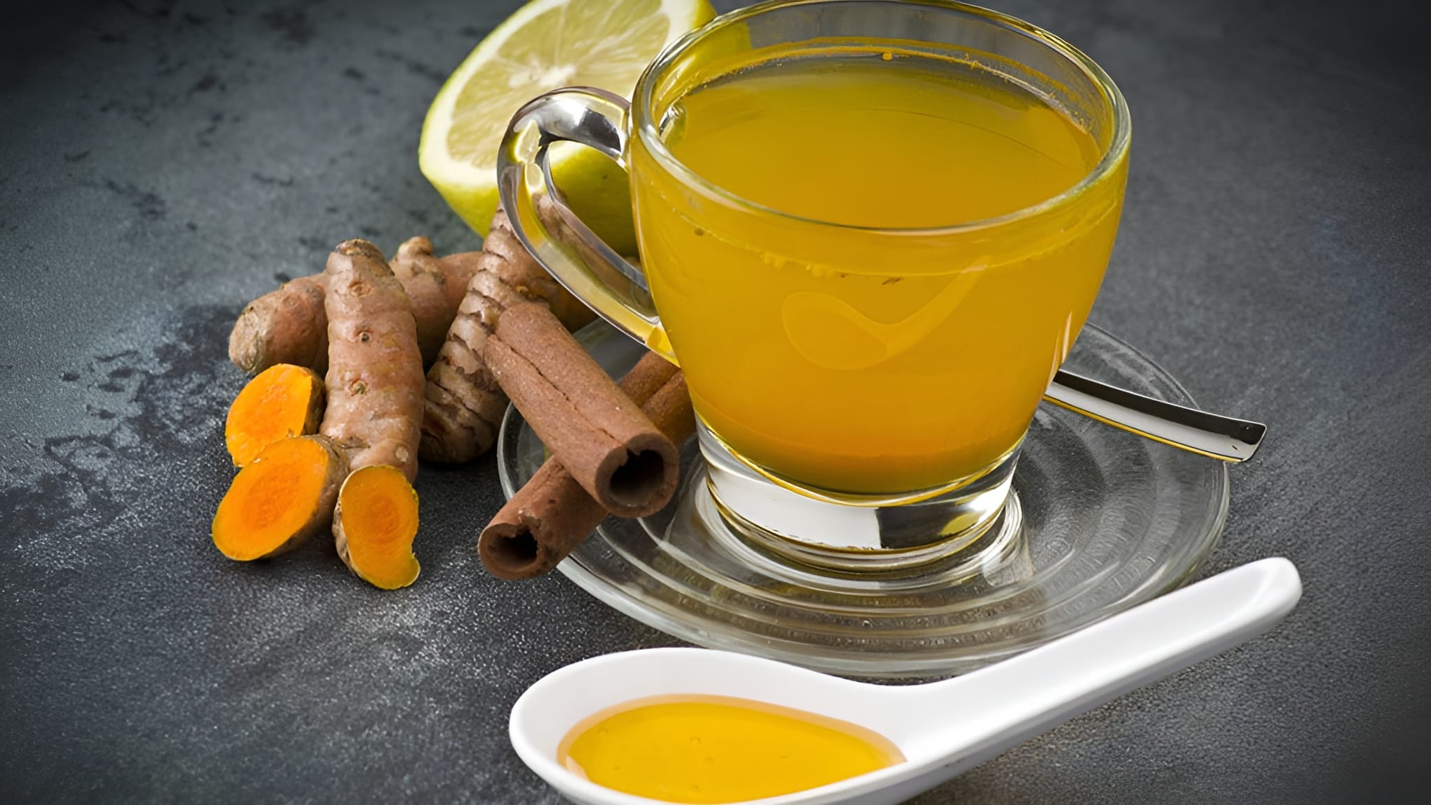 An image of turmeric root with some turmeric wellness tea.