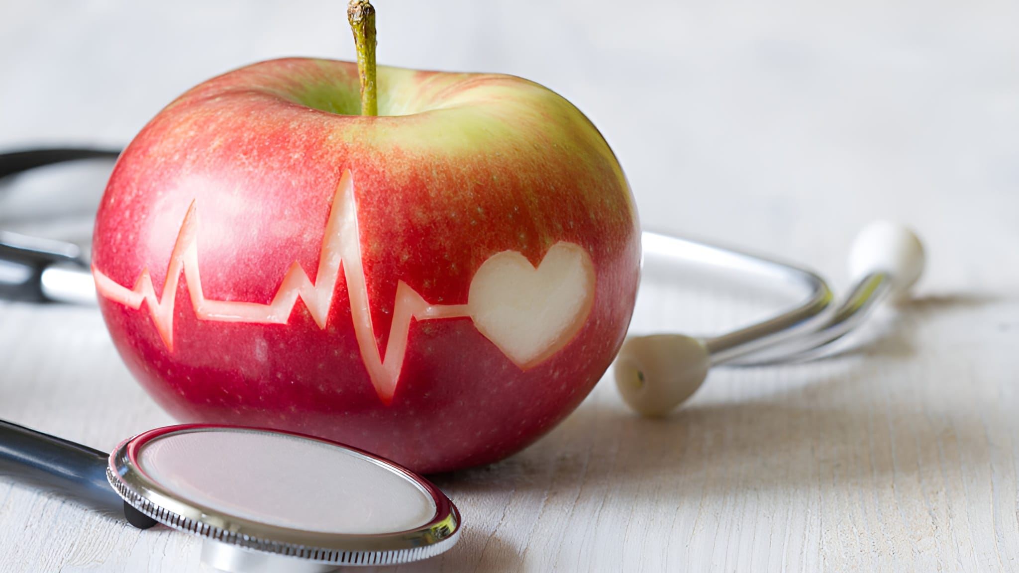 A fresh apple with a stable heartbeat carved into it. Apples contain many Vitamins for Blood Circulation.