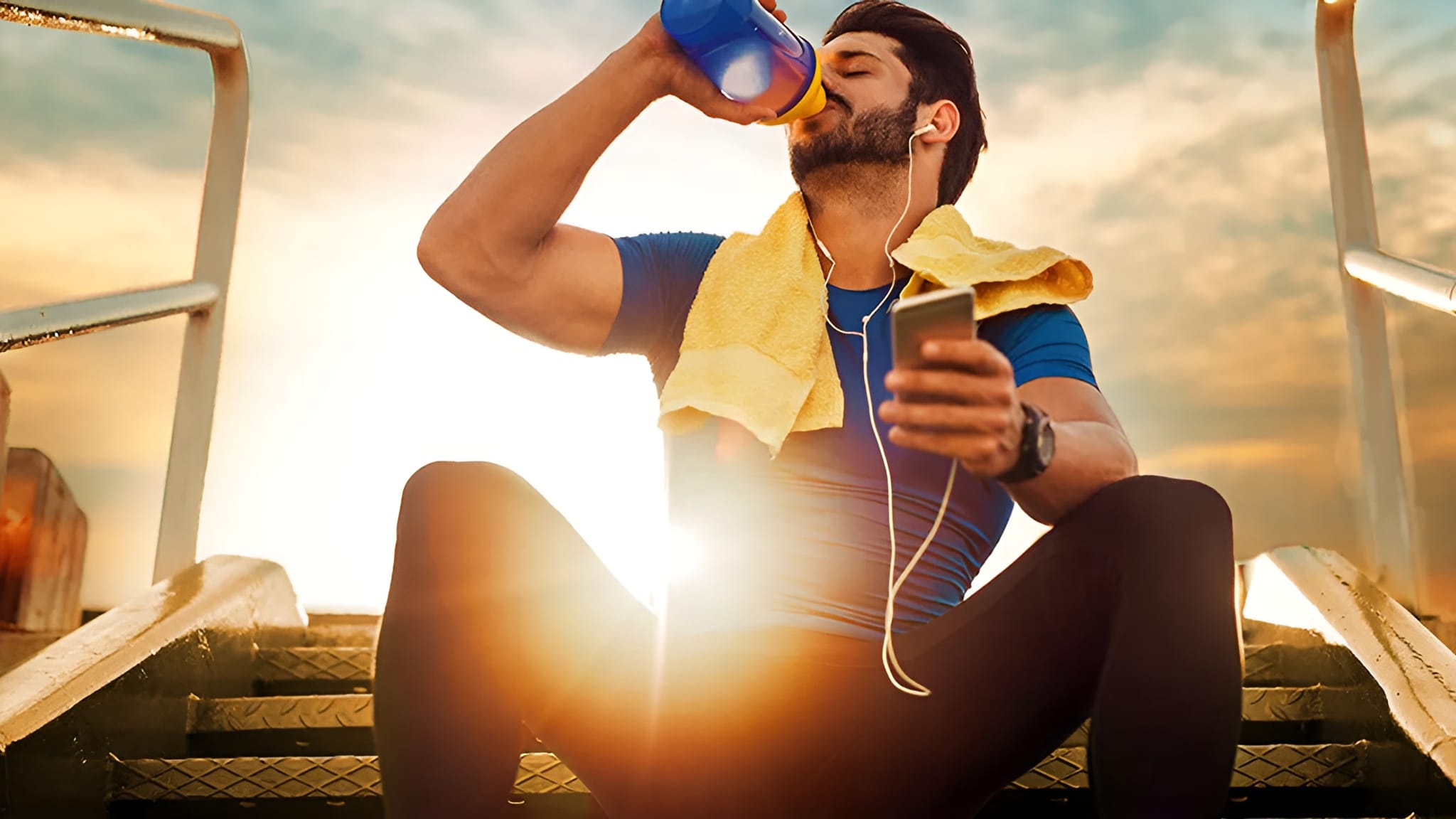 A man involved in fitness activities, flushing down his vitamins for energy with some water.